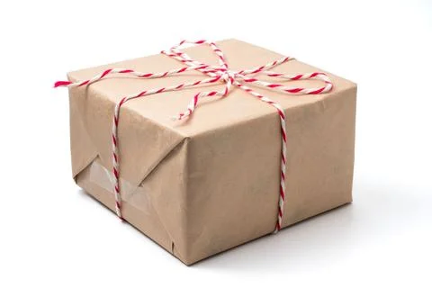 Gift package wrapped in brown paper on white background. Stock Photos