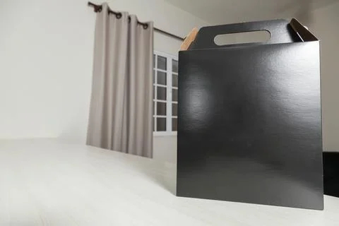 Gift packaging on the wooden table with space for advertising and copy space. Fotos Stock