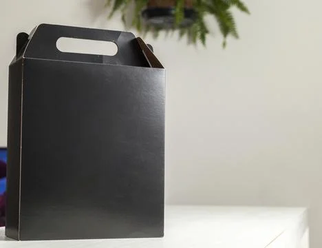 Gift packaging on the wooden table with space for advertising and copy space. Fotos Stock