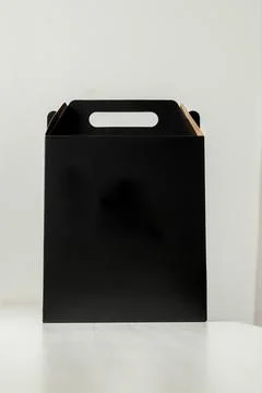 Gift packaging on the wooden table with space for advertising and copy space. Fotos Stock