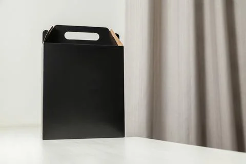 Gift packaging on the wooden table with space for advertising and copy space. Fotos Stock