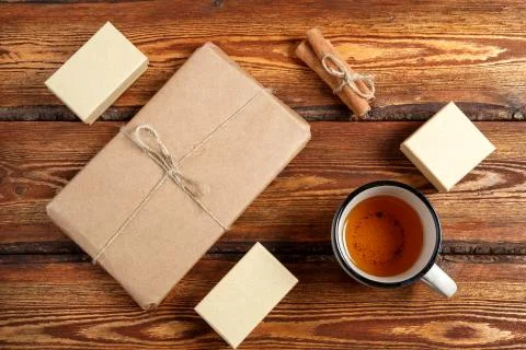 Gift Packed in eco-friendly biodegradable cardboard and a glass of tea on a d Stock Photos