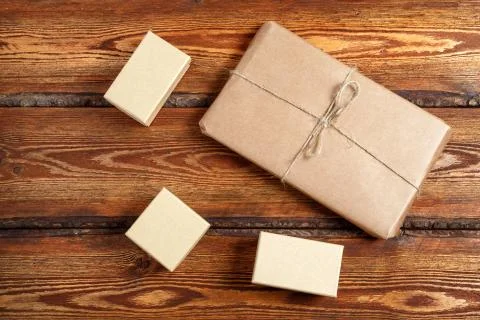 Gift Packed in eco-friendly biodegradable cardboard on dark old wooden backgr Stock Photos