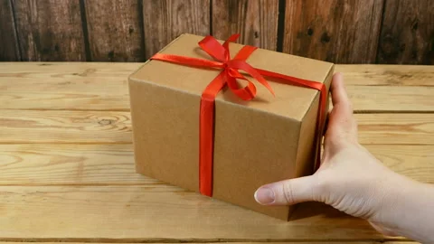 Gift parcel box with ribbon red bow, brown carton parcel, surprise Video stock 157651171
