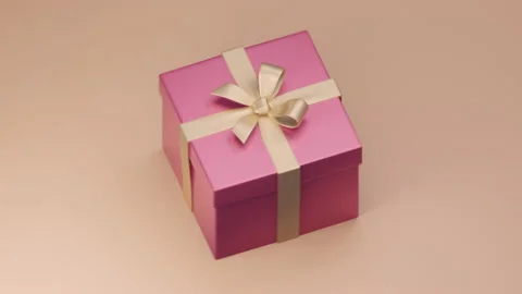 Gift, present box animation. Rose gold ribbons, pink colored paper box Stockbeeldmateriaal 158669015