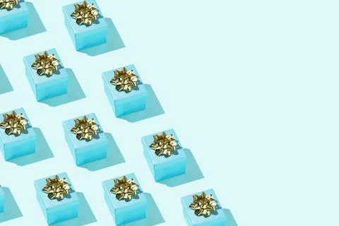 Gift presents pattern with golden bow on the mint background Stock Photos