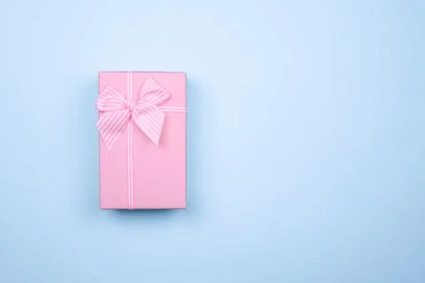 Gift rectangular pink box with bow on a pure blue background Stock Photos