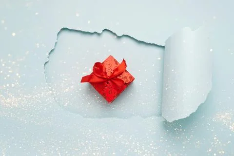 Gift with a red bow on the background big hole on a paper background mint color Stock Photos