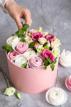 Gift set in the box - white and pink marshmallows and beautiful flowers on th Stock Photos