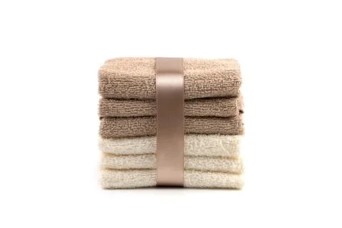 Gift set of white and light brown Terry towels on a white background. Stock Photos