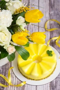 Gift set - yellow mousse cake and a large Spring medley bouquet of beautiful  Stock Photos