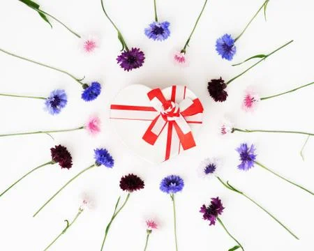 Gift in shape of heart with pattern flowers on white background. Stock Photos