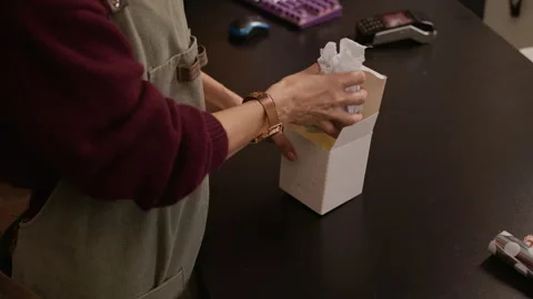 Gift Store Worker Placing Vase in Box Preparing Order for Client Stock Footage 321334352