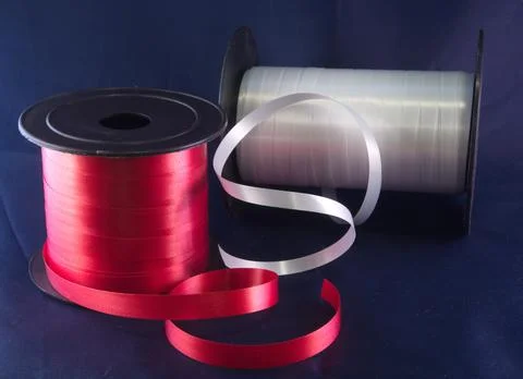 Gift strings on plastic reels. Stock Photos