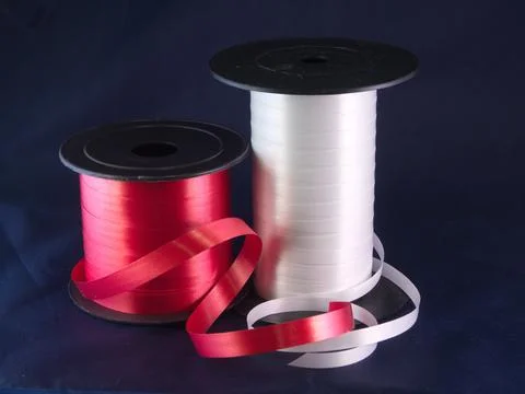 Gift strings on plastic reels. Stock Photos