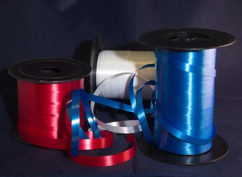 Gift strings on plastic reels. Stock Photos