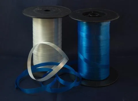Gift strings on plastic reels. Stock Photos