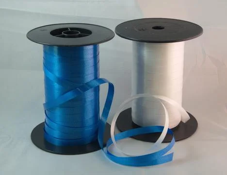 Gift strings on plastic reels. Stock Photos