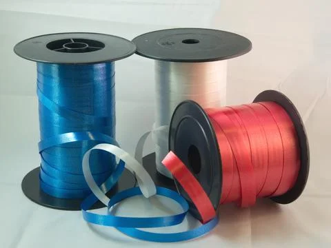 Gift strings on plastic reels. Stock Photos