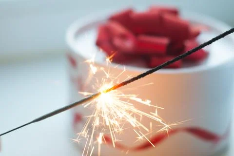 The gift on the table, Sparkler, white box with a red ribbon, Stock Photos