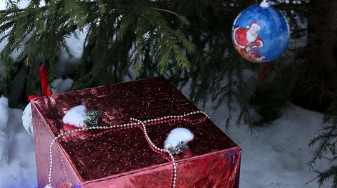 Gift under Christmas tree on the snow. Close-up Stock Footage 57451427