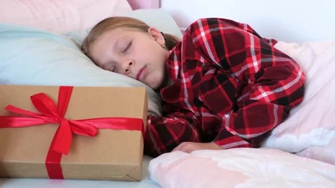 A gift under the pillow left by St. Nicholas for a child. A happy, emotional Stock Footage 318717887