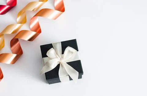 A gift on a white background. Open gift box with red ribbon on white backgrou Stock-Fotos