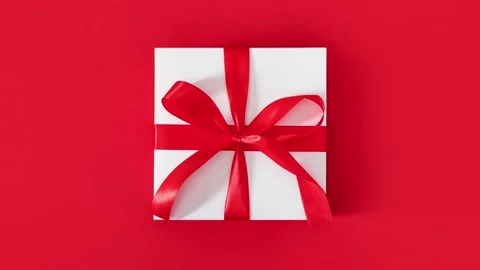 Gift white box with red bow red background minimalist style Stock Footage 196542862