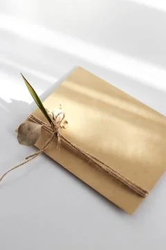 Gift wrap with envelope in white and beige colors Stock Photos