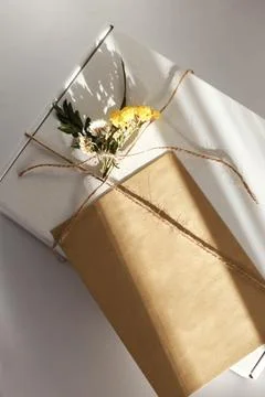 Gift wrap with envelope in white and beige colors Stock Photos