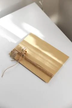 Gift wrap with envelope in white and beige colors Stock Photos