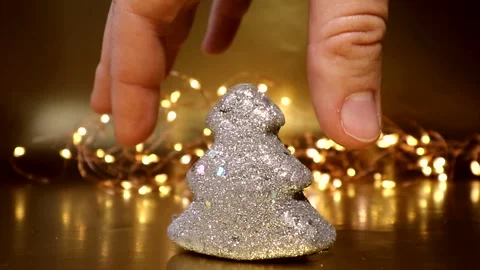 The gift wrapped in red wrapping paper is hidden behind a small toy silver tree Stock Footage 164968301