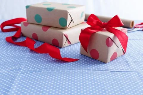 Gift wrapping and packing with boxes and red ribbon with space Stock Photos