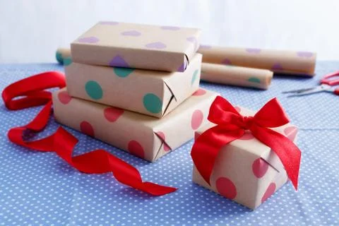 Gift wrapping and packing with boxes and red ribbon Stock Photos