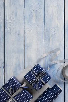 Gift wrapping items. Rolls of wrapping paper, scissors, ribbon, ready-wrapp.. Stock Photos