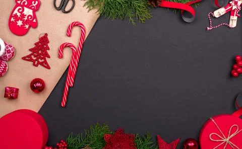 Gift wrapping. Packaging christmas present box in paper. Top view of black ta Stock Photos