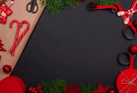 Gift wrapping. Packaging christmas present box in paper. Top view of black ta Stock Photos