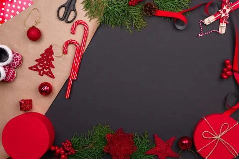 Gift wrapping. Packaging christmas present box in paper. Top view of black ta Stock Photos