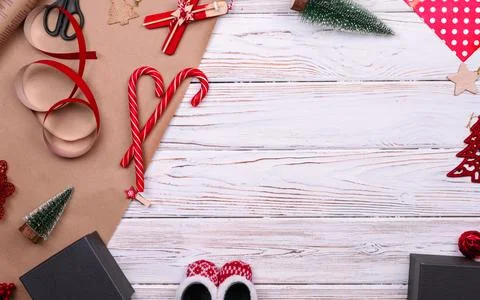 Gift wrapping. Packaging christmas present box in paper. Top view of white ta Stock Photos