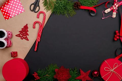 Gift wrapping. Packaging christmas present box in paper. Top view of black ta Stock Photos
