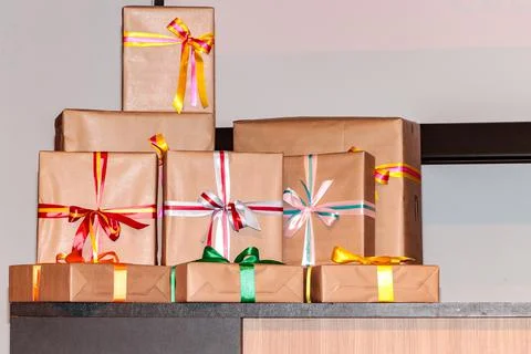 Gift wraps in various sizes, wrapped in kraft paper and with a bow of differe Stock Photos
