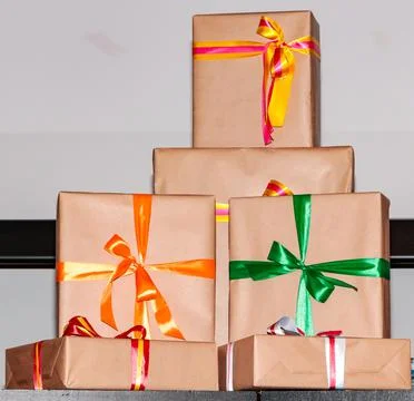 Gift wraps in various sizes, wrapped in kraft paper and with a bow of differe Stock Photos