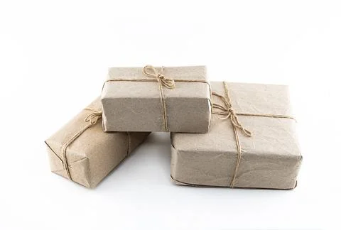 Giftbox in kraft brown paper stack of gifts on isolated white background Stock Photos