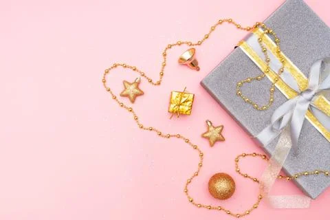 Gifts boxes or presents boxes with golden bows, star and ball on pink backgro Stock Photos
