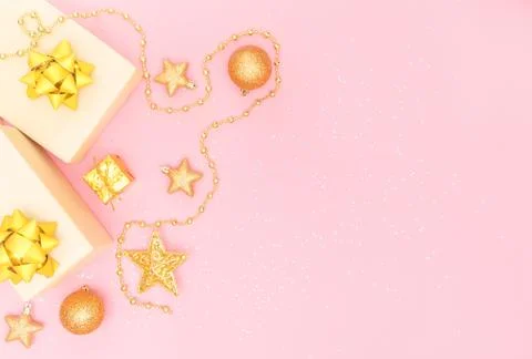 Gifts boxes or presents boxes with golden bows, star and ball on pink backgro Stock Photos