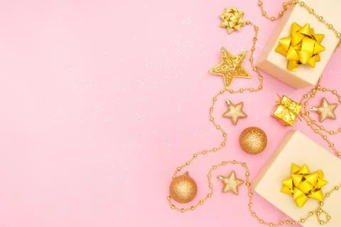 Gifts boxes or presents boxes with golden bows, star and ball on pink backgro Stock Photos