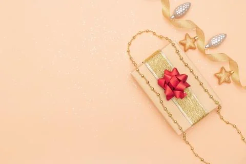 Gifts boxes or presents boxes with red bows, star and ball on golden backgrou Stock Photos