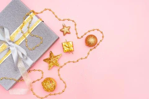 Gifts boxes or presents boxes with golden bows, star and ball on pink backgro Stock Photos