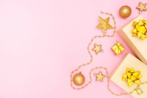Gifts boxes or presents boxes with golden bows, star and ball on pink backgro Stock Photos