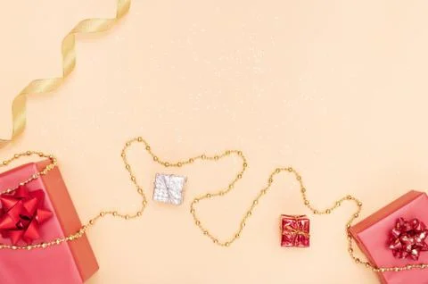 Gifts boxes or presents boxes with red bows, star and ball on golden backgrou Stock Photos